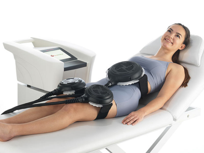 “Woman receiving a painless non-surgical muscle toning session with TESLAFormer”